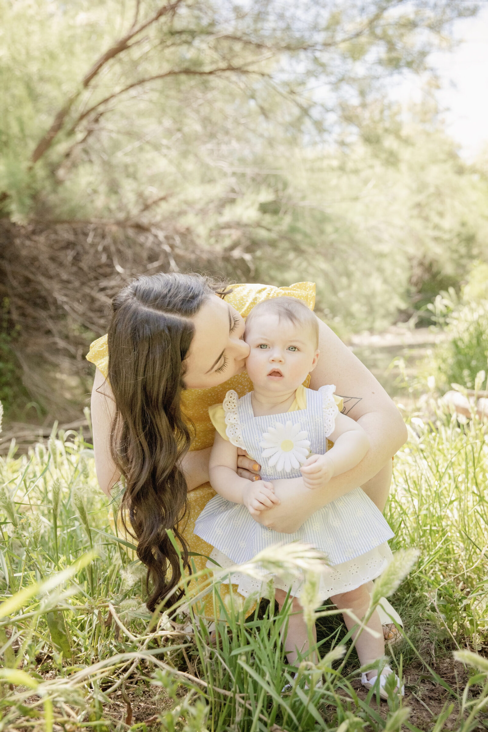 Mom kissing infant daughter cheek springtime photo in Peoria, Arizona