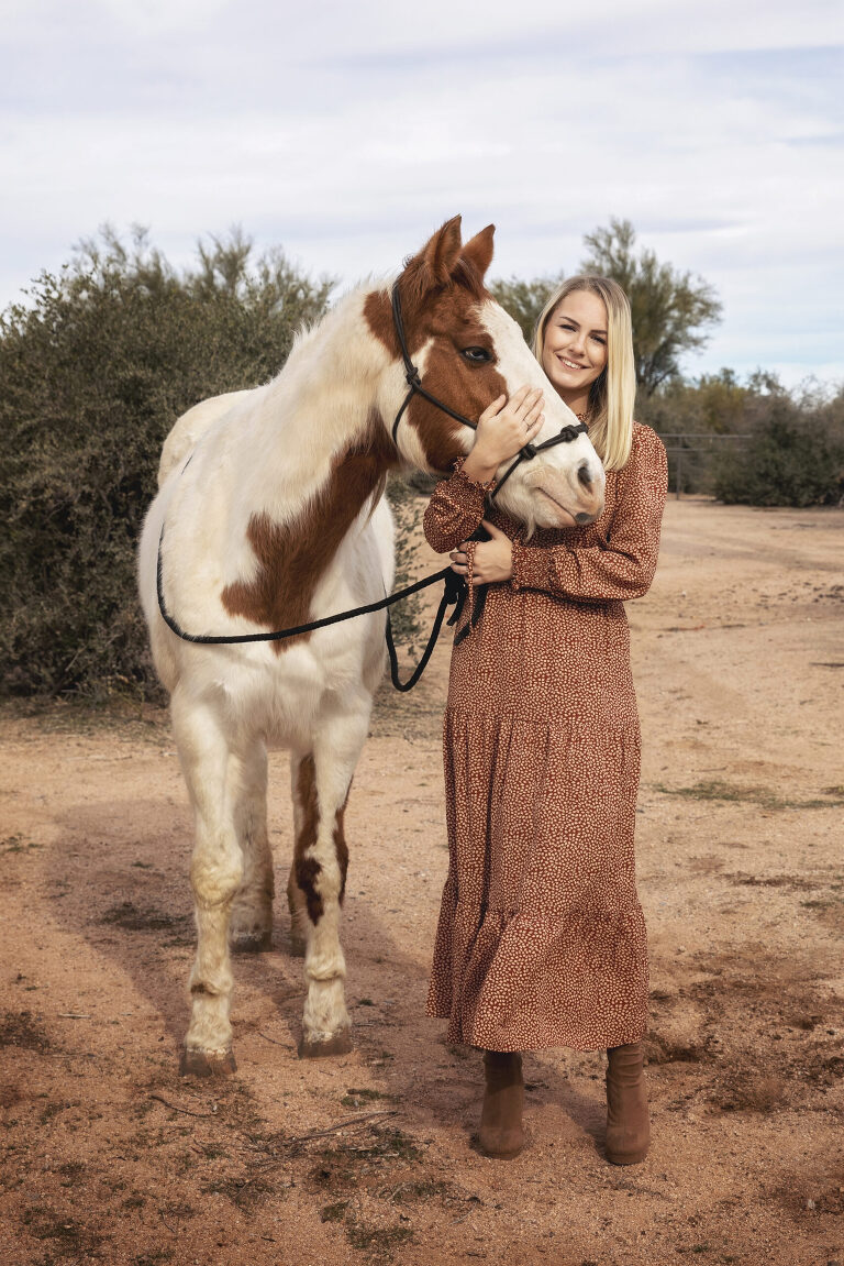 Woman in brown dress with horse in Arizona desert